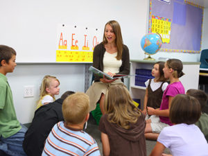 Elementary school teacher reads story to class